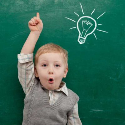 Cheerful smiling child at the blackboard. School conceptÿ